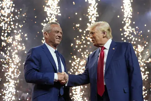 Republican presidential nominee former President Donald Trump shakes hands with Independent presidential candidate Robert F. Kennedy Jr. at a campaign rally at the Desert Diamond Arena, Friday, Aug. 23, 2024, in Glendale, Ariz. (AP Photo/Evan Vucci, File)