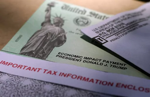 President Donald J. Trump's name is printed on a stimulus check issued by the IRS to help combat the adverse economic effects of the COVID-19 outbreak in this April 23, 2020 photo taken in San Antonio. Early in the pandemic, government relief checks became an attractive target for criminals. The problem has only gotten worse and postal authorities and bank officials are warning Americans to avoid mailing checks if possible, or at least to use a secure mail drop such as inside the post office. (A