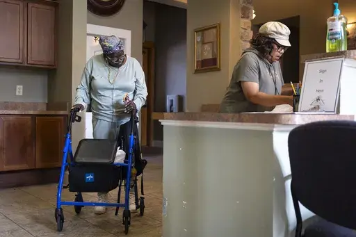 Patricia Johnican greets Lady Belinda Taylor as she passes through a common kitchen area after Wednesday bingo at Commons of Grace Senior on Wednesday, Sept. 25, 2024, in Houston. (AP Photo / Annie Mulligan)