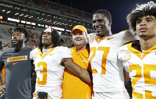 Tennessee head coach Josh Heupel, center, and defensive lineman James Pearce Jr. (27) celebrate with their team after defeating Oklahoma during an NCAA college football game Saturday, Sept. 21, 2024, in Norman, Okla. (AP Photo/Alonzo Adams)