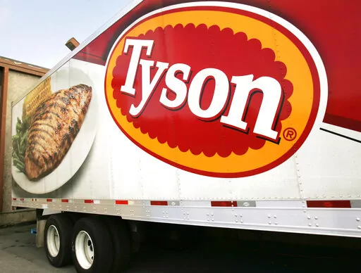 A Tyson Foods, Inc., truck is parked at a food warehouse on Oct. 28, 2009, in Little Rock, Ark. Thirty-four Tyson Foods employees, former employees and family members filed a lawsuit against the Arkansas-based company Monday, March 6, 2023, saying it failed to take appropriate precautions during the early days of the COVID pandemic. (AP Photo/Danny Johnston, File)