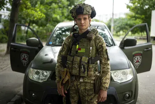 Ukrainian medic Serhiy Chornobryvets poses for a photo on Aug. 20, 2022, in Kharkiv, Ukraine. Chornobryvets, who won praise for his bravery in the siege of Mariupol, now works to save soldiers on the front lines of Ukraine's war with Russia. (AP Photo/Evgeniy Maloletka)