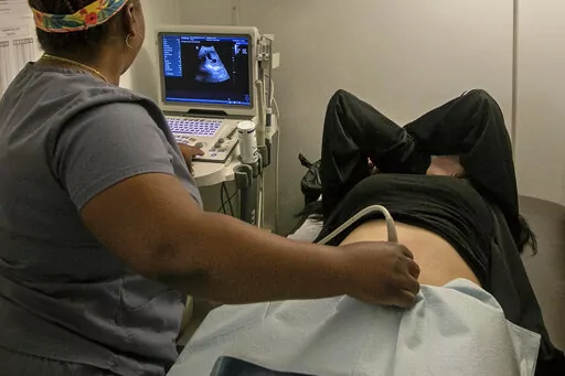 An operating room technician performs an ultrasound on a patient at an abortion clinic in Shreveport, La., Wednesday, July 6, 2022. The abortion bans taking effect after the nation's highest court overturned Roe v. Wade in June 2022 vary greatly in how they define when a pregnancy can be ended. (AP Photo/Ted Jackson)