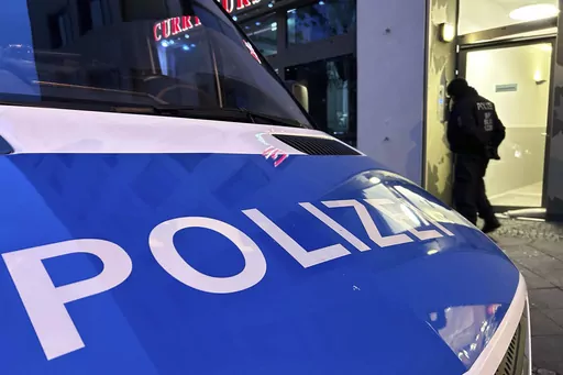 A police vehicle stands on the street during a raid in Berlin-Adlershof in Berlin, Thursday, Nov. 23, 2023. Hundreds of police officers searched the properties of Hamas members and followers in Germany on Thursday morning with the majority of the raids taking place in Berlin.(Sven Kaeuler/dpa via AP)