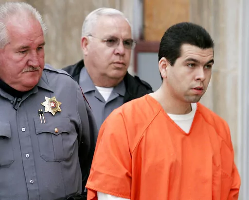Anthony Sanchez, right, is escorted into a Cleveland County courtroom for a preliminary hearing in Norman, Okla., on Feb. 23, 2005. The Oklahoma death row inmate convicted of raping and killing a University of Oklahoma dance student in 1996 is seeking to have his death sentence thrown out, alleging in a court filing Friday, Feb. 3, 2023, that his late father is the actual killer. (Jaconna Aguirre/The Oklahoman via AP, File)