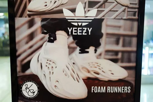 A sign advertises Yeezy shoes made by Adidas at Kickclusive, a sneaker resale store, in Paramus, N.J., Oct. 25, 2022. Adidas brought in 400 million euros ($437 million) from the first release of Yeezy sneakers left over after breaking ties with Ye, the rapper formerly known as Kanye West, as the German sportswear maker tries to offload the unsold shoes and donate part of the proceeds to groups fighting antisemitism and other forms of hate. The first batch of shoes released in June, which sold ou