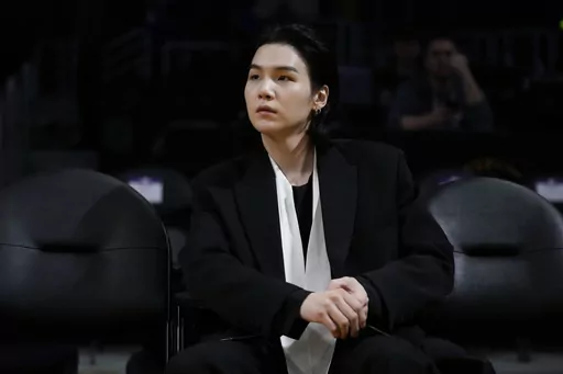 BTS member Suga attends an NBA basketball game between the Los Angeles Lakers and the Dallas Mavericks on Jan. 12, 2023, in Los Angeles. Suga has become the third member of BTS to begin South Korea’s compulsory military service. BTS' label, Big Hit Music, said in a statement on Monday, Aug. 7, 2023, that Suga "has initiated the military enlistment process by applying for the termination of his enlistment postponement.” (AP Photo/Jae C. Hong, File)