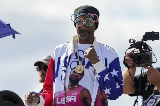 U.S. artist Snoop Dogg gestures during the men's skateboarding park finals at the 2024 Summer Olympics, on Aug. 7, 2024, in Paris, France. (AP Photo/Frank Franklin II, File)