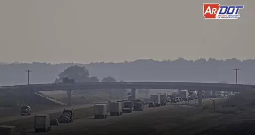 This traffic camera photo released by the Arkansas Department of Transportation shows traffic backed up after a deadly pileup on Highway 67 as smoke fills the air from a grass fire burning on Tuesday, Oct. 3, 2023, near Swifton, Ark. (Arkansas Department of Transportation via AP)