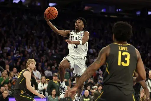 Duke guard Jeremy Roach drives to the basket past Baylor guard Langston Love (13) during the first half of an NCAA college basketball game, Dec. 20, 2023, in New York. (AP Photo/Adam Hunger)