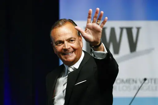 Businessman Rick Caruso waves at the start of a mayoral debate at the Student Union Theater on the California State University, Los Angeles campus on Sunday, May 1, 2022. Los Angeles is a heavily Democratic city, but voters this year could take a right turn. Caruso, a billionaire former longtime Republican who sits on the Ronald Reagan Presidential Foundation board, is a leading candidate for mayor and is promising to expand, not defund, police. (Ringo Chiu/Los Angeles Times via AP, File)