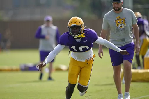 LSU linebacker Harold Perkins (10) runs through drills during their NCAA college football practice in Baton Rouge, La., Wednesday, Aug. 17, 2022. Harold Perkins was named to The Associated Press preseason All-America team, Monday, Aug. 21, 2023. (AP Photo/Gerald Herbert, File)