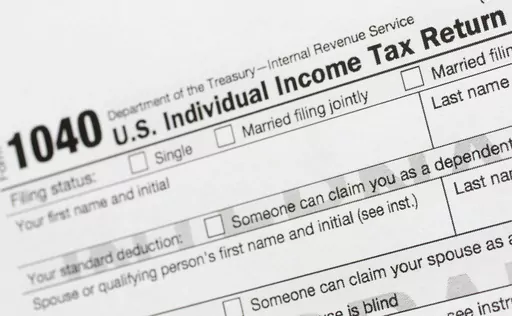 A portion of the 1040 U.S. Individual Income Tax Return form is shown July 24, 2018, in New York. The IRS has been tasked with looking into how to create a government-operated electronic free-file tax return system for all. Congress has directed the IRS to report in on how such a system might work. (AP Photo/Mark Lennihan, File)