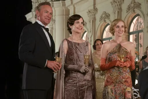 This image released by Focus Features shows Hugh Bonneville, from left, Elizabeth McGovern and Laura Carmichael in a scene from "Downton Abbey: A New Era." (Ben Blackall/Focus Features via AP)