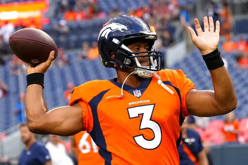 Denver Broncos quarterback Russell Wilson (3) warms up prior to an NFL preseason football game against the Dallas Cowboys, Saturday, Aug. 13, 2022, in Denver. (AP Photo/Jack Dempsey)