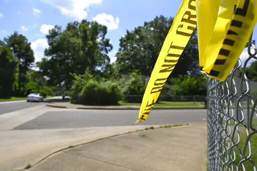 A remnant of crime scene tape hangs on a fence in the neighborhood of Whitehaven in Memphis, Tenn., where Ezekiel Kelly was arrested on Sept. 8, 2022, after he livestreamed himself driving around Memphis shooting at people in seemingly random attacks the night before, Sept. 7, 2022. A court hearing for Kelly, who is charged with murder in connection with the series of shootings in Memphis, was postponed Tuesday, Sept. 27, 2022, when three state witnesses did not show up for the proceedings. (AP 