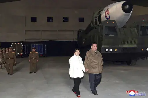This photo provided on Nov. 19, 2022, by the North Korean government shows North Korean leader Kim Jong Un, right, and his daughter inspecting a missile at Pyongyang International Airport in Pyongyang, North Korea, Friday, Nov. 18, 2022. Independent journalists were not given access to cover the event depicted in this image distributed by the North Korean government. The content of this image is as provided and cannot be independently verified. Korean language watermark on image as provided by s