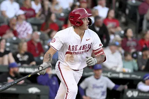 Arkansas batter Kuhio Aloy (25) watches the ball after hitting a home run against Central Arkansas during an NCAA baseball game, March 11, 2025, in Fayetteville, Ark. (AP Photo/Michael Woods, File)