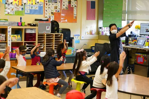 First grade teacher Suzy Tom leads a class and demonstrates the order of character strokes at the Alice Fong Yu school in San Francisco, Tuesday, Aug. 30, 2022. The school is the nation's first Chinese immersion public school and provides Cantonese instruction from kindergarten until the 8th grade. While Cantonese may be on a downward trajectory, it's not dying. Online campaigns, independent Chinese schools and Cantonese communities in and outside of Chinatowns are working to ensure future gener