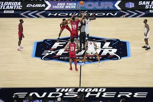 Florida Atlantic center Vladislav Goldin (50) and San Diego State forward Nathan Mensah (31) jump for the tipoff during the first half of a Final Four college basketball game in the NCAA Tournament on Saturday, April 1, 2023, in Houston. (AP Photo/Godofredo A. Vasquez, file)
