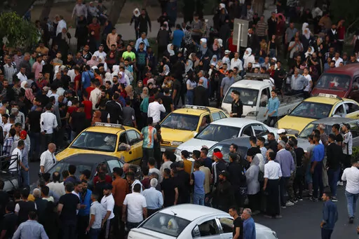 Dozens of Syrians wait at the President's Bridge in Damascus for relatives they hope would be among those released from prison May 3, 2022, on the second day of the Muslim Fitr holiday. A newly released video taken in 2013 showed blindfolded men who were thrown into a large pit and shot dead by Syrian agents, who then set the bodies on fire. The video stirs new fears over the fate of tens of thousands who went missing during Syria's long-running conflict and serves as a grim reminder of the war'