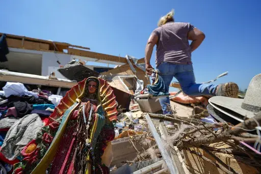 A Guadalupe Virgin statue is seen in the destroyed home of Juana Landeros, who rode out deadly tornado with her husband and her 9-year-old son when it rolled through the previous night, Sunday, May 26, 2024, in Valley View, Texas. Powerful storms left a wide trail of destruction Sunday across Texas, Oklahoma and Arkansas after obliterating homes and destroying a truck stop where drivers took shelter during the latest deadly weather to strike the central U.S. (AP Photo/Julio Cortez)