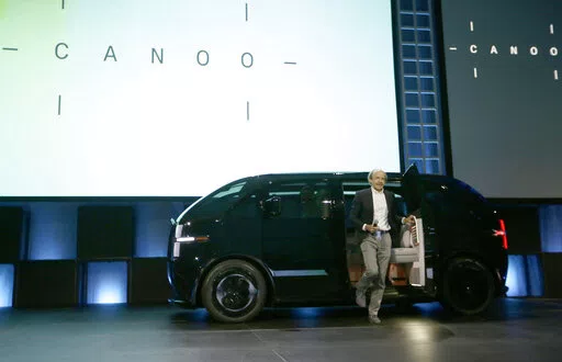 Ulrich Kranz, co-Founder & CEO of Canoo, arrives in his first electric van model at AutoMobility LA auto show in Los Angeles, on Nov. 19, 2019. Oklahoma Gov. Kevin Stitt is planning to award a state-record $15 million to electric vehicle-manufacturer Canoo for a planned manufacturing facility in the state. The Tulsa World reports the money from the governor's Quick Action Closing Fund will support Canoo's plan for a 1,500-job factory in Pryor, Okla. (AP Photo/Damian Dovarganes, File)