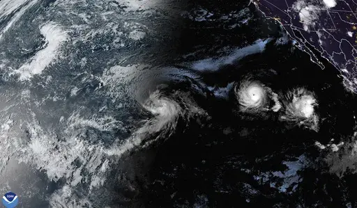 This satellite image provided by the National Oceanic and Atmospheric Administration (NOAA) shows Tropical Storm Hone and Hurricane Gilma located southeast of Hawaii, Thursday, Aug. 22, 2024. (NOAA via AP)