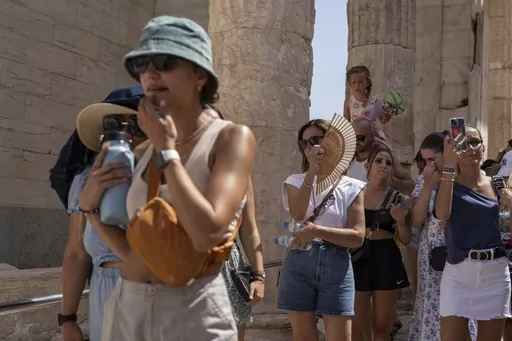 Tourists visit the ancient Acropolis hill during a heat wave in Athens, Greece, on July 21, 2023. Climate change is making heat waves crawl slower across the globe and last longer with higher temperatures over larger areas, a new study finds. (AP Photo/Petros Giannakouris, File)
