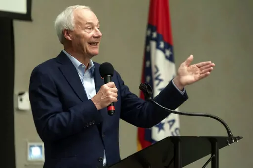 In this July 15, 2021, file photo, Arkansas Gov. Asa Hutchinson speaks during a town hall meeting in Texarkana, Ark. Hutchinson is Arkansas' top Republican and is leaving office in January with strong approval numbers, but he's been conspicuously absent from his state's primary campaigns. Other top GOP figures like former President Donald Trump, Sen. Tom Cotton and Sarah Sanders are instead frequenting the state's airwaves leading up to Tuesday, May 24, 2022 election.  (Kelsi Brinkmeyer/The Texa