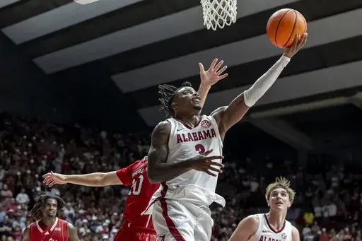 Alabama guard Latrell Wrightsell Jr. (3) gets past Arkansas State guard Avery Felts (10) for a shot during the second half of an NCAA college basketball game, Friday, Nov. 8, 2024, in Tuscaloosa, Ala. (AP Photo/Vasha Hunt)