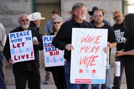 Anti-abortion supporters stand outside at the Arizona capitol, May 1, 2024, in Phoenix. Reeling from a string of defeats, anti-abortion groups and their Republican allies in state governments across the country are deploying an array of strategies to counter proposed ballot initiatives intended to protect reproductive rights or prevent voters from having a say in the fall. (AP Photo/Matt York, File)