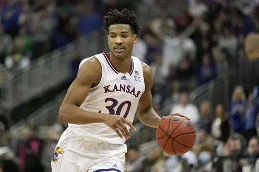 Kansas guard Ochai Agbaji drives during the second half of an NCAA college basketball championship game against Texas Tech in the Big 12 Conference tournament in Kansas City, Mo., Saturday, March 12, 2022. Kansas won 74-65. (AP Photo/Charlie Riedel)