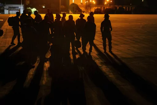 Saudi soldiers who were on a humanitarian mission in Sudan prepare to board a plane to Jeddah, Saudi Arabia, at Port Sudan airport, Thursday, May 11, 2023. The conflict between the country's military and a rival paramilitary group has killed hundreds and displaced hundreds of thousands since it broke out in mid-April, creating a humanitarian crisis inside the country and at its borders. (AP Photo/Amr Nabil)