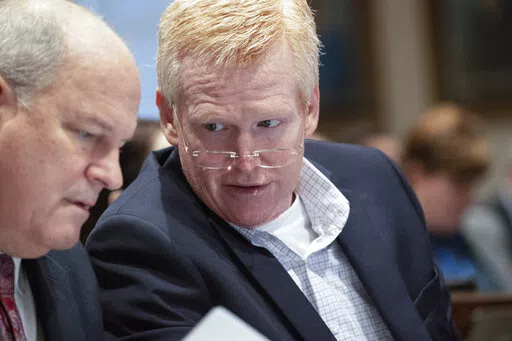 Alex Murdaugh, right, leans over to talk with his attorney Jim Griffin in his double murder trial at the Colleton County Courthouse in Walterboro, S.C., Friday, Feb. 3, 2023. The 54-year-old attorney is standing trial on two counts of murder in the shootings of his wife and son at their Colleton County home and hunting lodge on June 7, 2021. (Andrew J. Whitaker/The Post And Courier via AP, Pool)