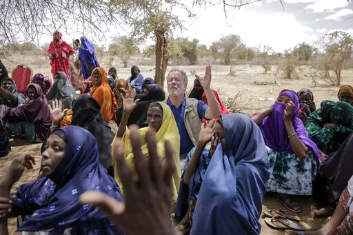 World Food Program chief David Beasley meets with villagers in the village of Wagalla in northern Kenya Friday, Aug. 19, 2022. The United States is stepping up to buy about 150,000 metric tons of grain from Ukraine in the next few weeks for an upcoming shipment of food aid from ports no longer blockaded by war, the World Food Program chief has told The Associated Press. (AP Photo/Brian Inganga)