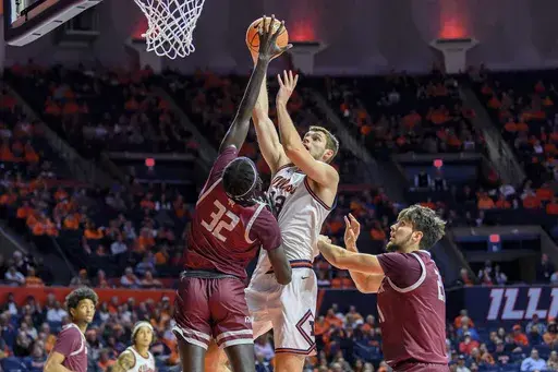 Illinois' Tomislav Ivisic (13) shoots over Oakland's Tuongthach Gatkek (32) during the first half of an NCAA college basketball game Monday, Nov. 25, 2024, in Champaign, Ill. (AP Photo/Craig Pessman)