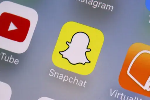 The Snapchat app is seen on a mobile device in New York, Aug. 9, 2017. As concerns about social media's impact on teen psychology continue to rise, platforms from Snapchat to TikTok to Instagram are bolting on new features they say will make their services safer and more age appropriate. (AP Photo/Richard Drew, File)