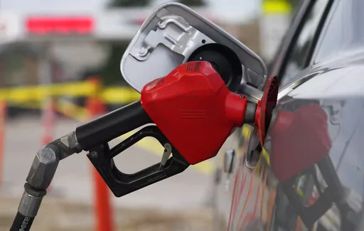 A motorist fills up the tank on a sedan, on July 22, 2022, in Saratoga, Wyo. Gasoline prices are sliding back toward the $4 mark for the first time in more than five months — good news for consumers who are struggling with high prices for many other essentials. (AP Photo/David Zalubowski, File)