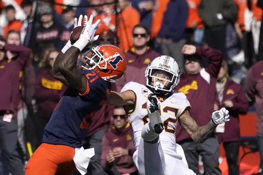 Illinois defensive back Jartavius Martin (21) intercepts a pass from Minnesota backup quarterback Athan Kaliakmanis intended for wide receiver Michael Brown-Stephens, right, during an NCAA college football game Oct. 15, 2022, in Champaign, Ill. The Washington Commanders continued bolstering their secondary in the second round of the NFL draft Friday, April 28, taking Martin with the 47th pick. Martin, whose given name is Jartavius but prefers to go by Quan, was a five-year starter with the Illin