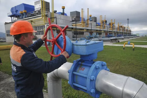 A worker at a Ukrainian gas station in Volovets, western Ukraine, on Oct. 7, 2015. The gas is still flowing from Russian even as bullets and missiles fly in Ukraine. But the war is raising huge questions about the energy ties between Europe and Russia. The conflict is helping keep oil and gas prices high due to fears of a possible reduction in supplies, and consumers will continue to face financial stress from that. (AP Photo/Pavlo Palamarchuk, File)