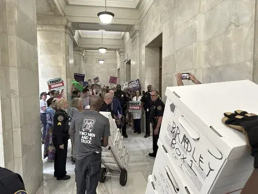 Boxes containing signatures supporting a proposed ballot measure to scale back Arkansas' abortion ban are delivered to a room in the state Capitol in Little Rock, Ark. Friday, July 5, 2024. Organizers submitted petitions to try and get the proposals on the November ballot. (AP Photo/Andrew DeMillo)