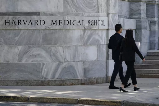 Pedestrians walk towards the Harvard Medical School, Aug. 18, 2022, in Boston. Jeremy Pauley has pleaded guilty to federal charges stemming from the theft and sale of human body parts taken from Harvard Medical School and an Arkansas mortuary, Friday, Sept. 8, 2023. (AP Photo/Charles Krupa, File)