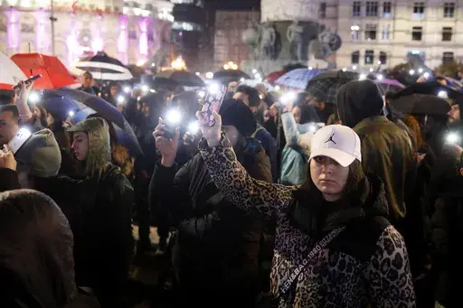 Protesters light their mobile phones during a rally, for the victims of a massive nightclub fire in the town of Kocani, in Skopje, North Macedonia, Monday, March 24, 2025. (AP Photo/Boris Grdanoski)