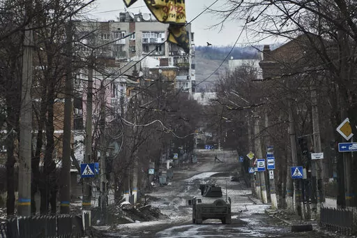 Ukrainian soldiers ride in a Humvee in Bakhmut, Donetsk region, Ukraine, Wednesday, Dec. 21, 2022. (AP Photo/Libkos, File)
