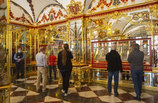 Visitors stand in the Jewel Room during the reopening of the Green Vault Museum in Dresden's Royal Palace of the Dresden State Art Collections (SKD) in Dresden, Germany, May 30, 2020. A German court on Tuesday May 16, 2023, convicted five men of particularly aggravated arson in combination with dangerous bodily injury, theft with weapons, damage to property and intentional arson in the spectacular theft of 18th-century jewels from the Dresden museum in 2019. (AP Photo/Jens Meyer, file)