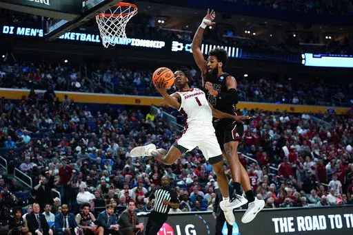 Arkansas guard JD Notae (1) shoots against New Mexico State forward Johnny McCants during the first half of a college basketball game in the second round of the NCAA men's tournament Saturday, March 19, 2022, in Buffalo, N.Y. (AP Photo/Frank Franklin II)