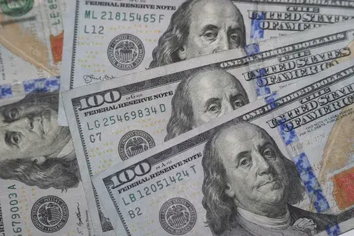 This Jan. 22, 2020, file photo shows the likeness of Benjamin Franklin on $100 bills in Dallas. Baby boomers are poised to pass on an enormous amount of wealth to their children and grandchildren over the next two decades. Financial experts recommend talking about potential inheritances early, while family members are still living, so you can prepare together. Being aware of your parents’ financial situation can also make it easier to provide assistance if they need it. (AP Photo/LM Otero, Fil