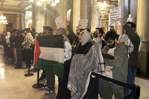 Protestors rally outside of the Indiana House chamber against House Bill 1002, which defines antisemitism and bans its teaching at Indiana schools, Thursday, Jan 18, 2024, in Indianapolis. Opponents to the bill say it could be used to shut down support for Palestine and criticism of Israel. The bill was passed unanimously and now advances to the state Senate. (AP Photo/Isabella Volmert)