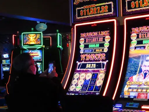 A gambler wins at a slot machine at the Ocean Casino Resort in Atlantic City, N.J., Feb. 10, 2022. The American Gaming Association said Wednesday, May 11, 2022, that America's commercial casinos had their best month ever in March 2022, winning $5.3 billion from gamblers. (AP Photo/Wayne Parry)